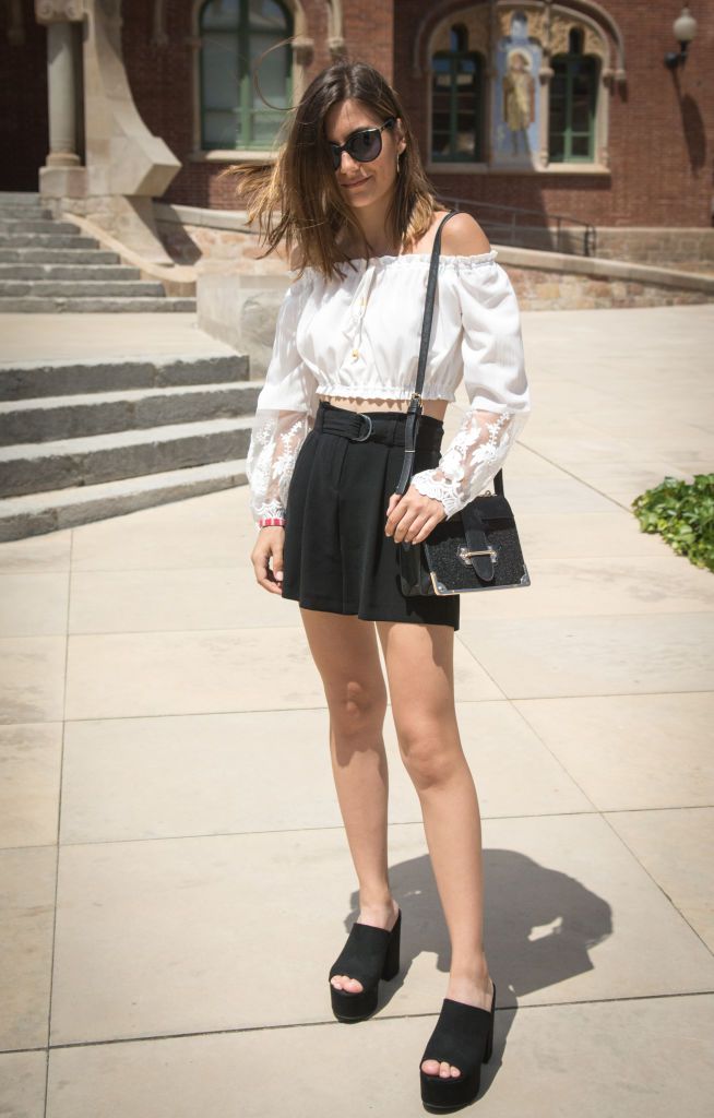 אִשָׁה wearing white blouse and black mini skirt