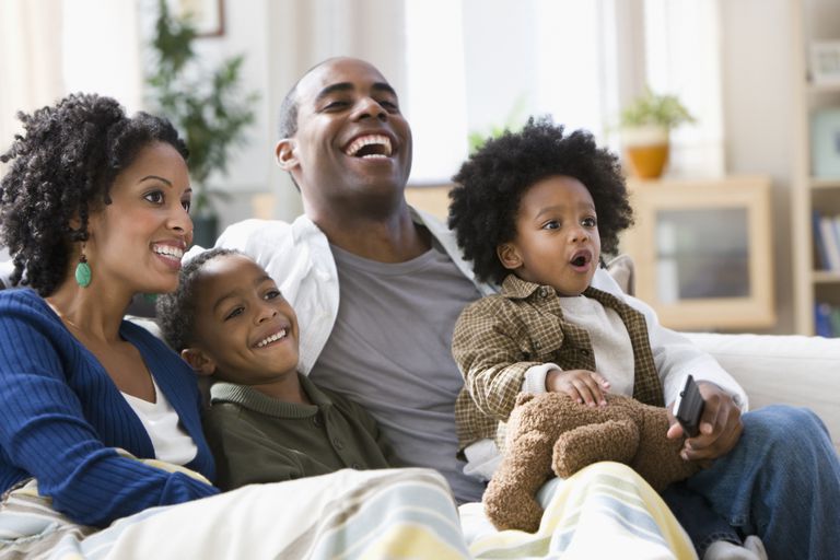 Afrika American family watching television together