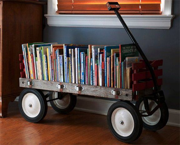 विंटेज wagon repurposed as a rolling book cart for childrens' books and toys