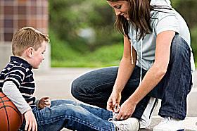 A mom enjoys playing outdoor games with her son.