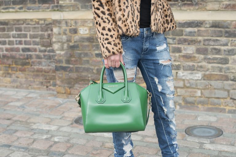 Ulica style photo of woman in distressed jeans and leopard coat