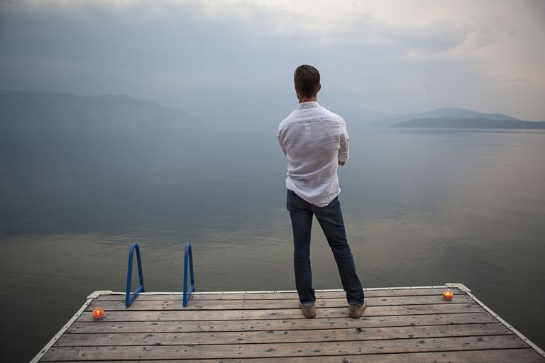 Man overlooking a lake.