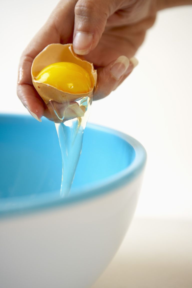 Kvinna cracking an egg