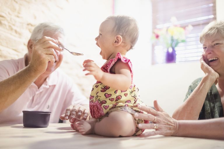 दादा spoon feeding granddaughter