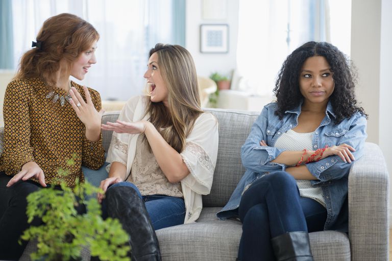 två women ignoring another woman on the same couch