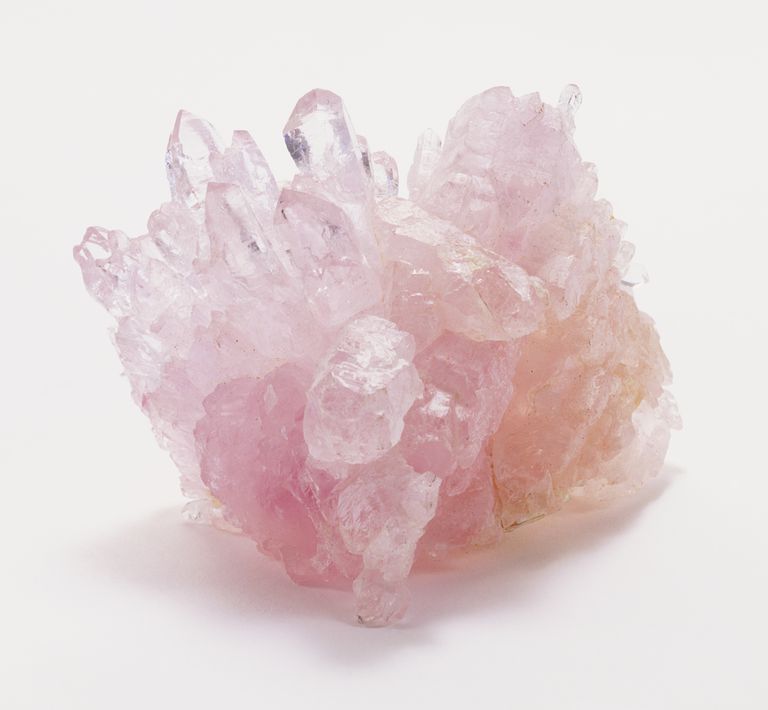 หายาก rose quartz crystals set in massive rose quartz, close up.
