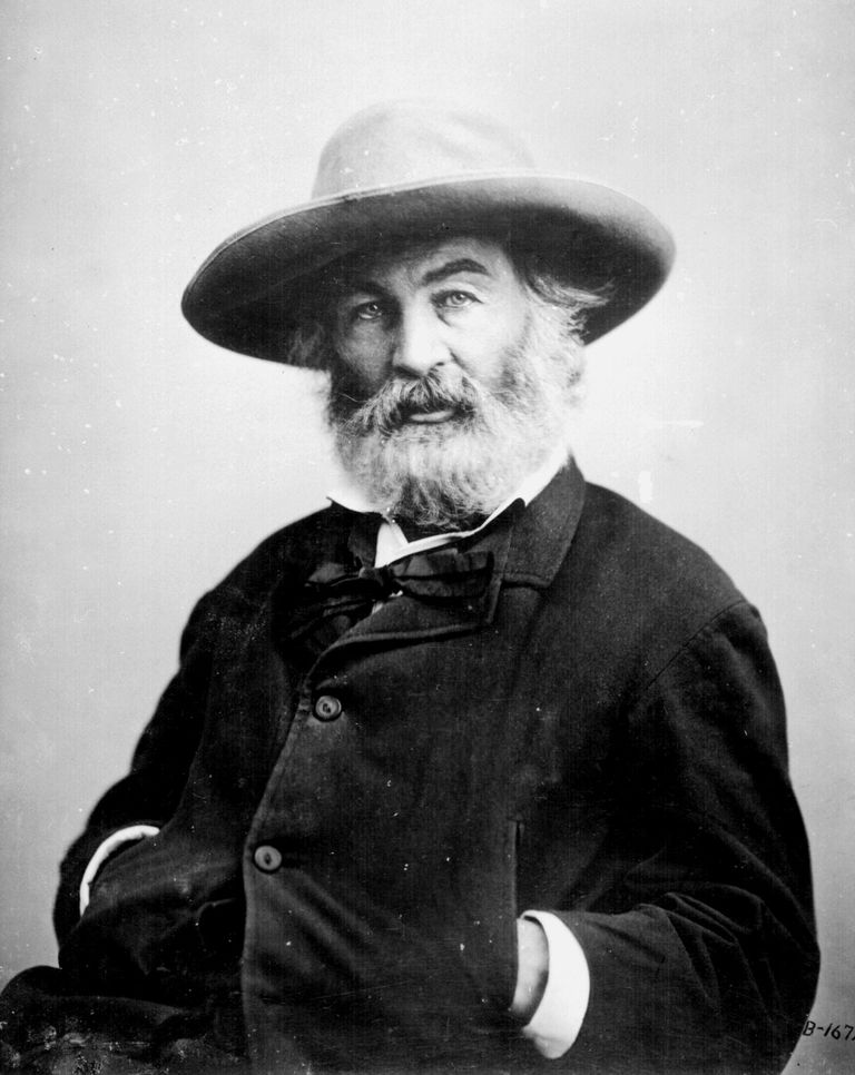 וולט Whitman, poet; half-length, seated, wearing hat.