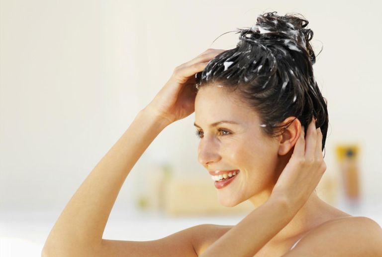 צַד view of a woman scrubbing her hair