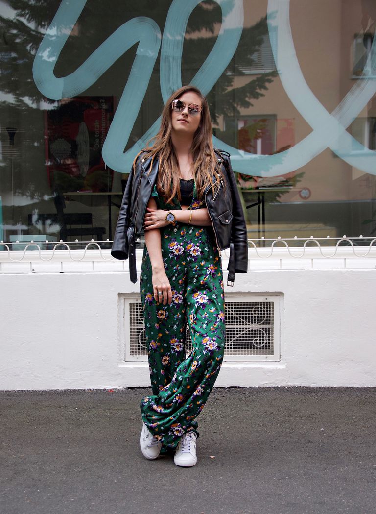 महिला wearing floral print jumpsuit and leather jacket