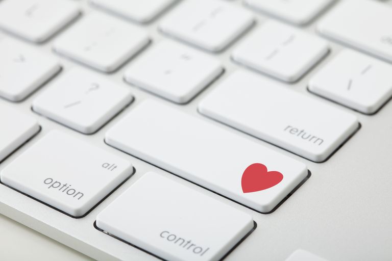 א closeup of a keyboard with red heart on it