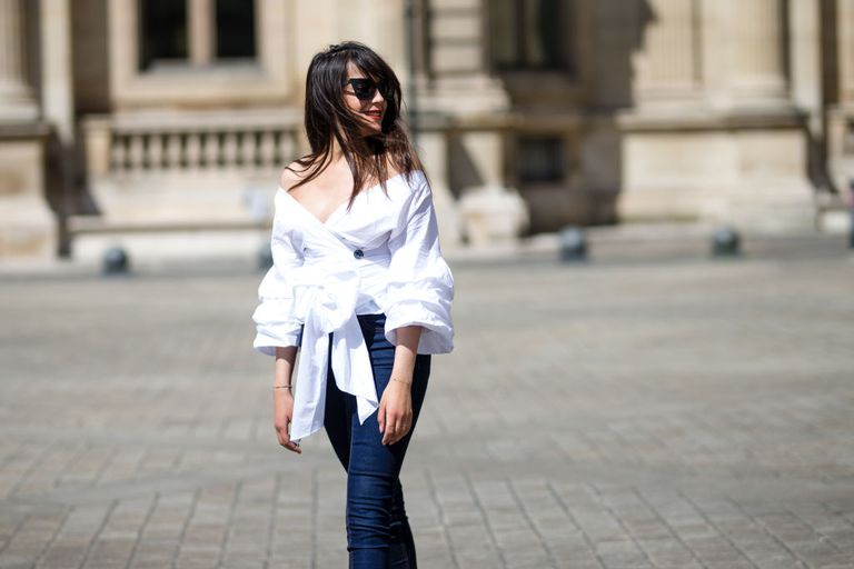फ्रेंच street style woman's fashion outfit in jeans and an off the shoulder top