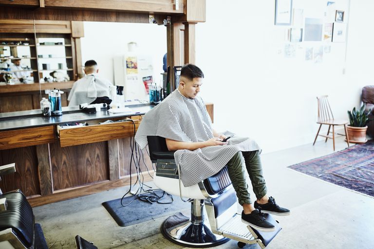 ชาย in barber chair at salon