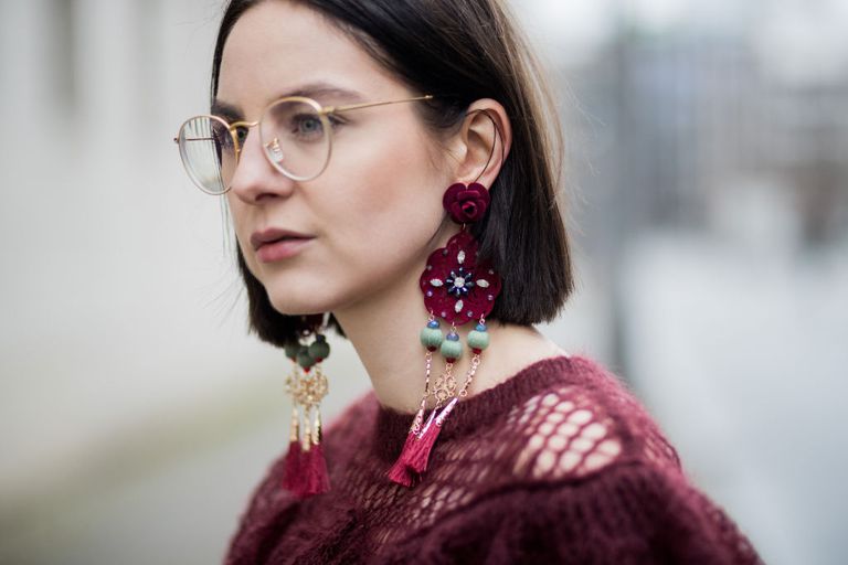 महिला wearing beaded tassel earrings
