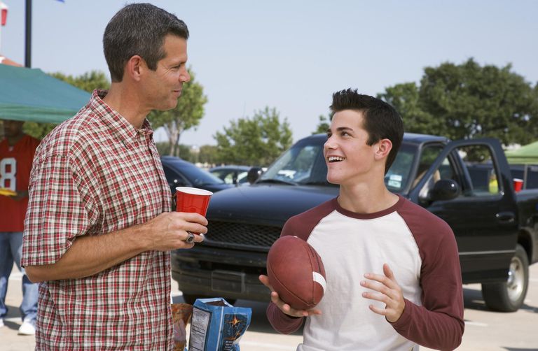 Far and teen son (13-15) at tailgate party.