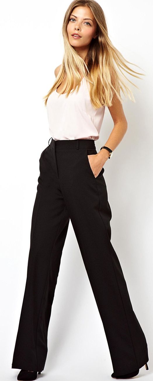 Model wearing black dress pants with wide legs, white sleeveless blouse, and black almond toe pumps.